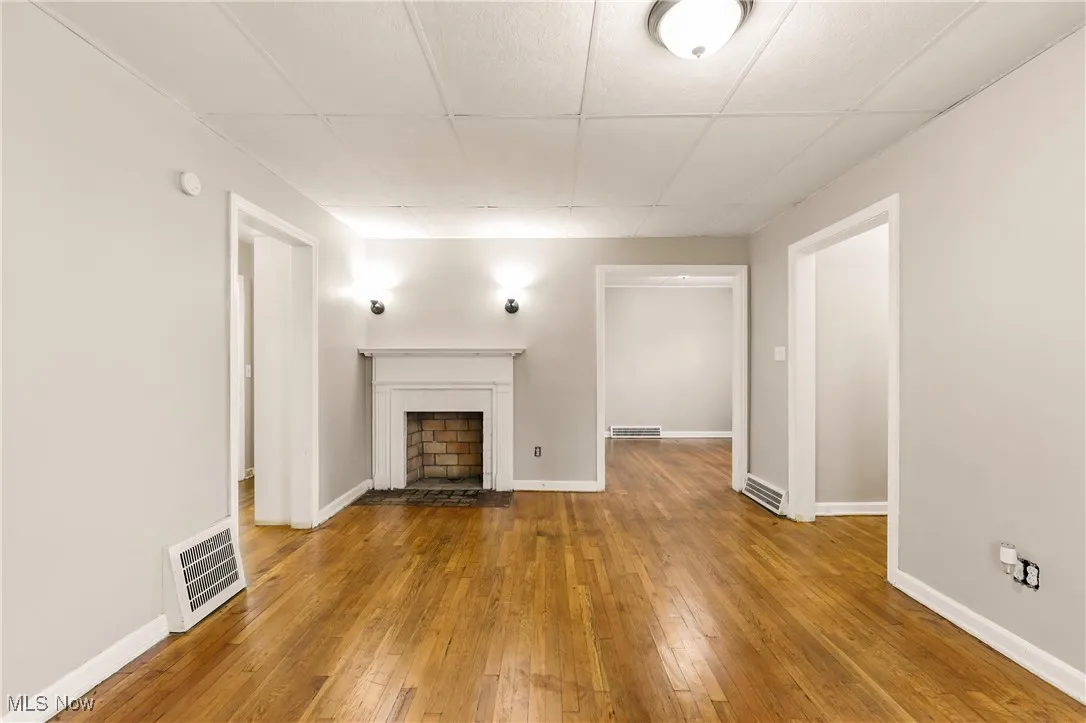Unfurnished living room with a fireplace and hardwood / wood-style flooring