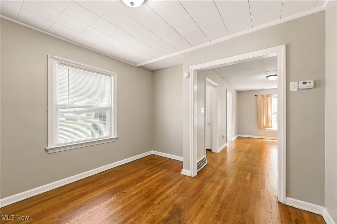 Spare room featuring hardwood / wood-style floors and baseboards