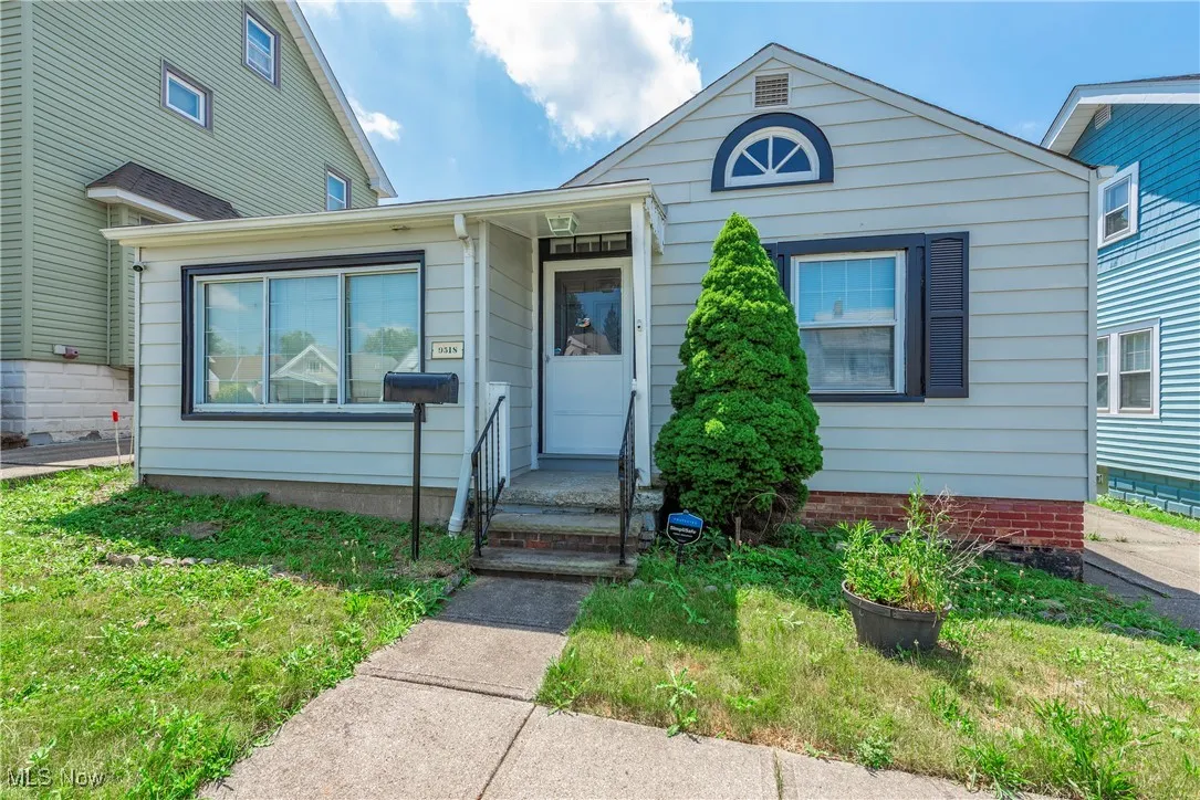 Bungalow-style home with a front yard