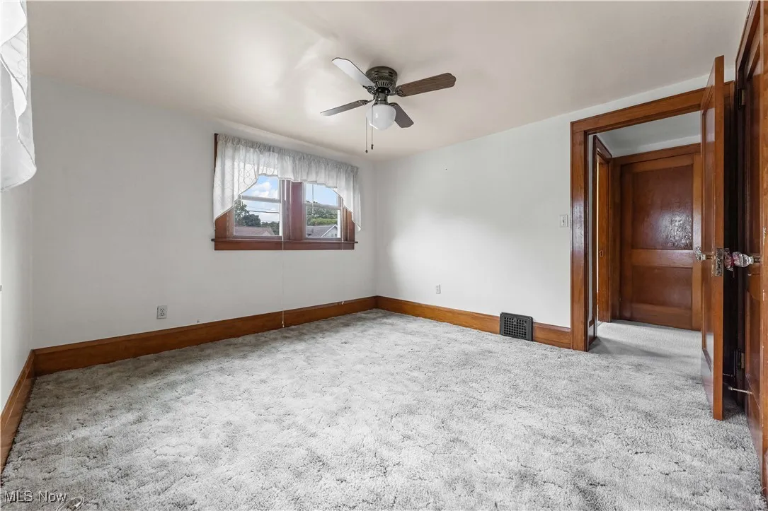 Spare room with carpet floors and ceiling fan
