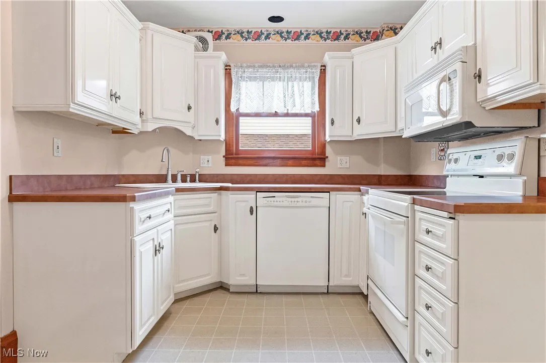 Kitchen with white appliances and white cabinets