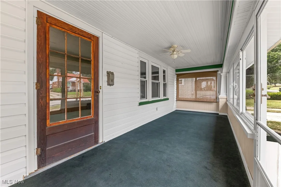 Unfurnished sunroom with ceiling fan and plenty of natural light