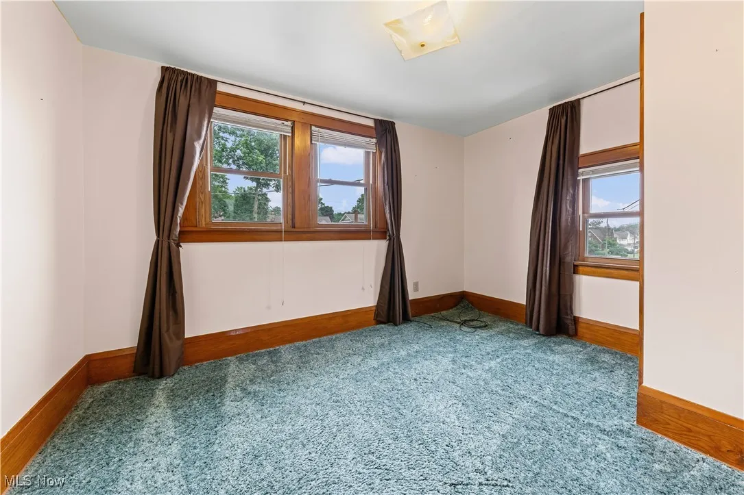 Carpeted empty room with healthy amount of natural light