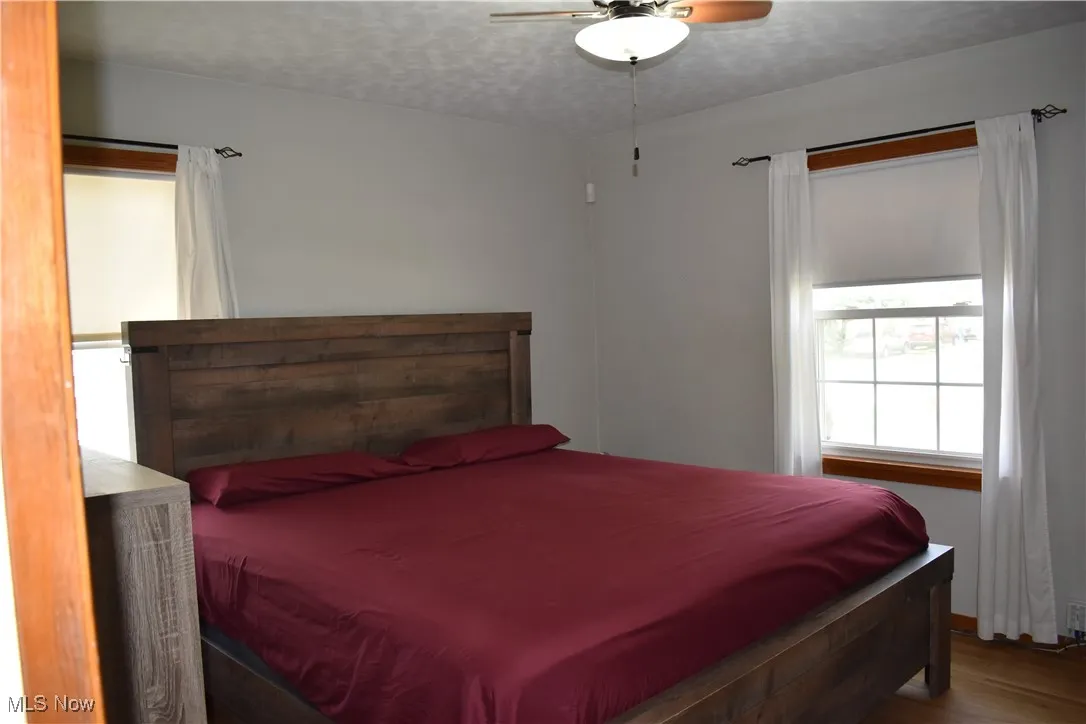 Bedroom with wood finished floors and ceiling fan