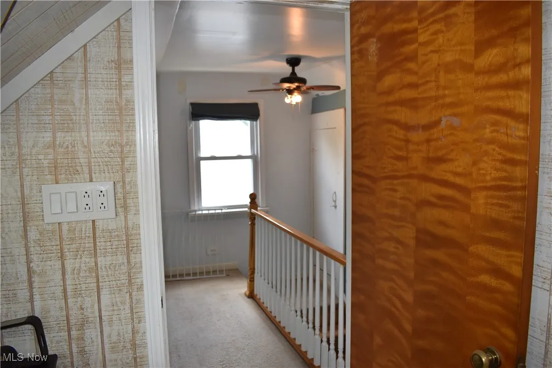 Hallway featuring carpet floors