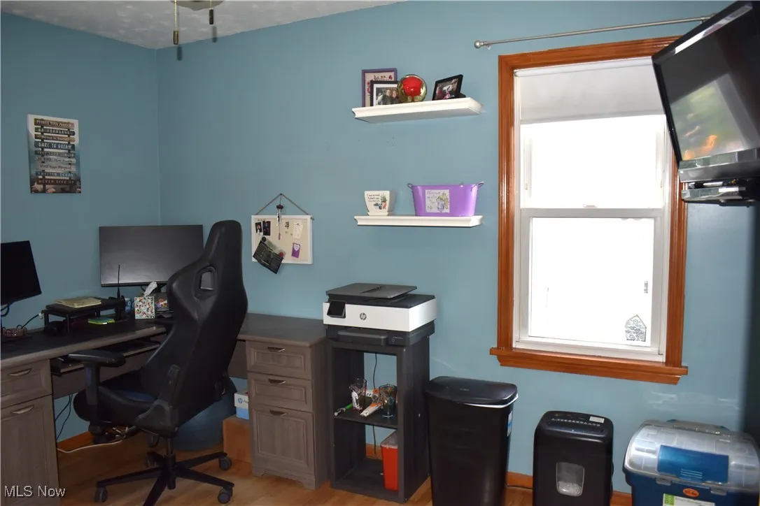 Bedroom currently used as office with wood finished floors
