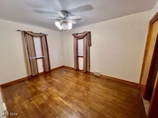 Spare room featuring a ceiling fan and wood finished floors
