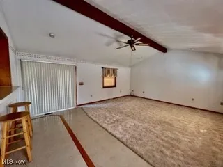 Unfurnished living room with a ceiling fan and carpet floors
