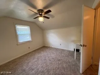Bonus room featuring lofted ceiling, a ceiling fan, and carpet