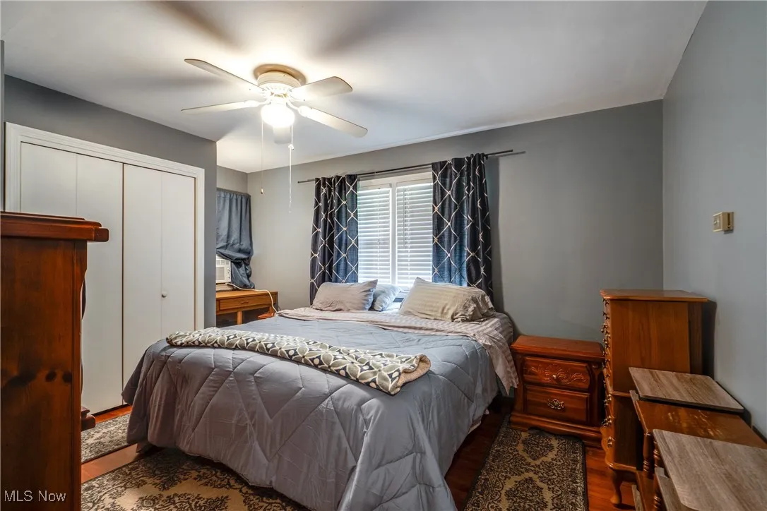 Bedroom featuring wood finished floors, a closet, and a ceiling fan