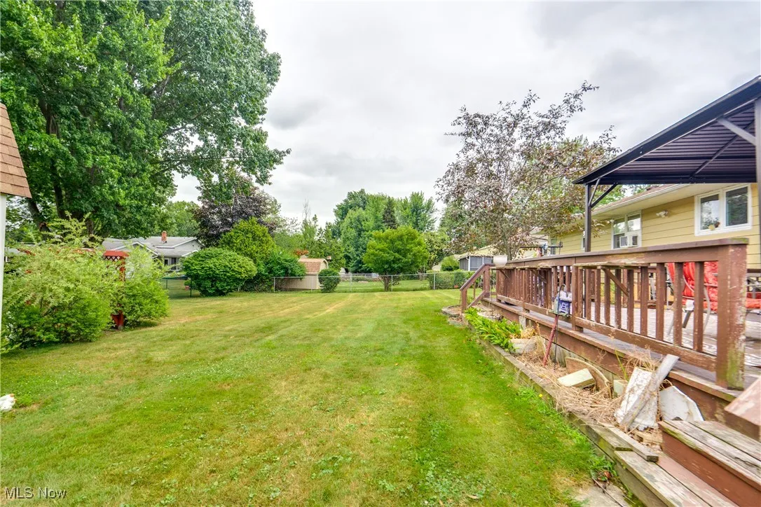Fenced backyard featuring a wooden deck