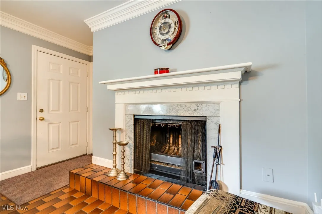 Detailed view of a tile fireplace and ornamental molding
