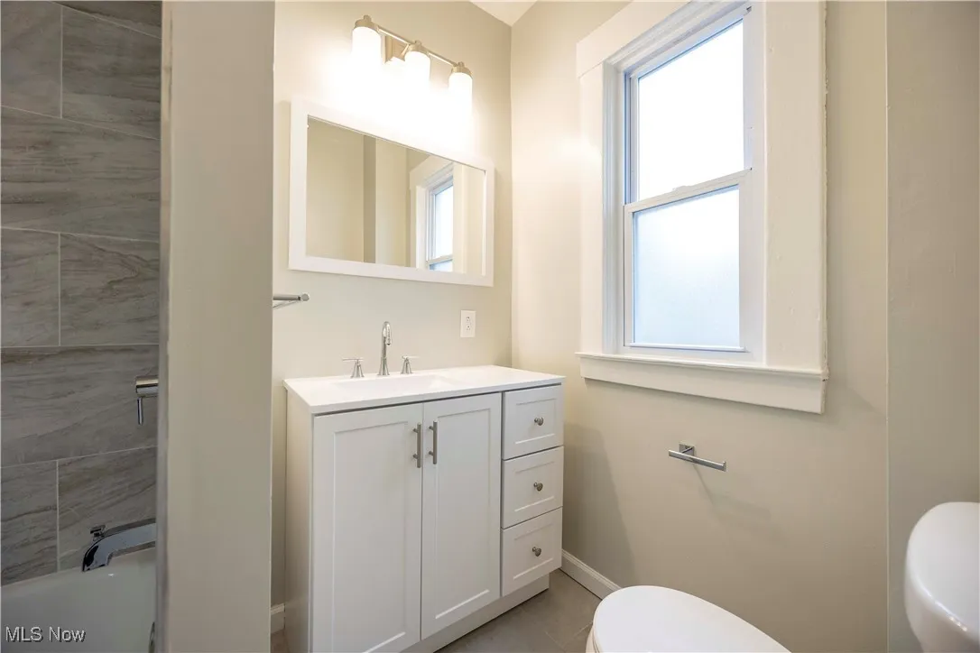 Full bathroom with plenty of natural light and vanity