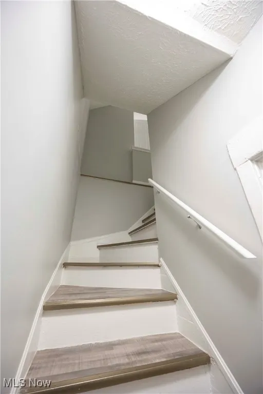 Stairs with a textured ceiling