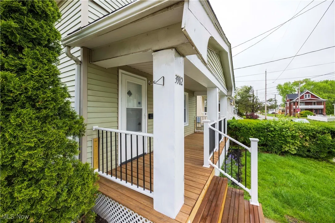 Wooden porch featuring a lawn