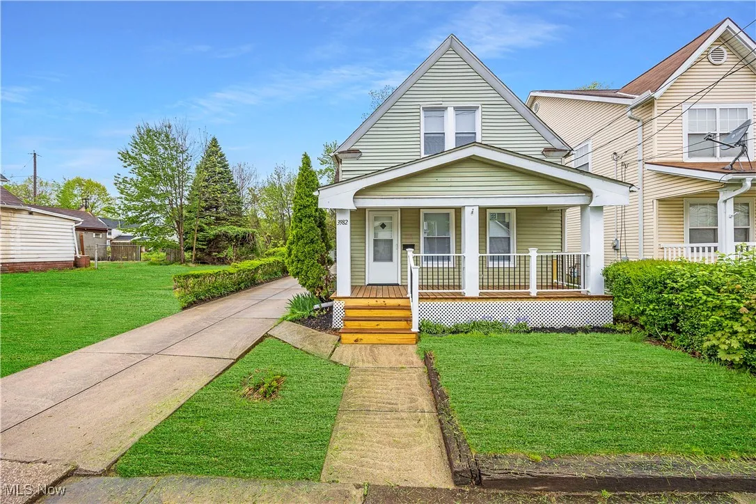 View of front of home with covered porch and a front lawn