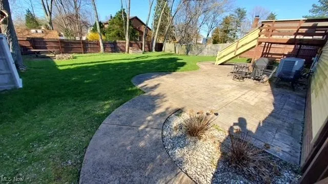 Fenced backyard featuring a patio