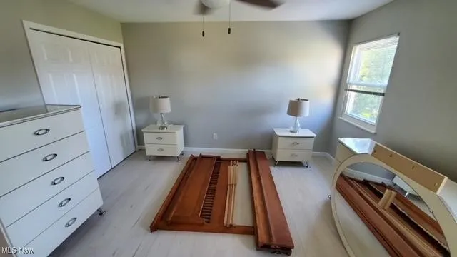 Bedroom with light wood-type flooring and a closet