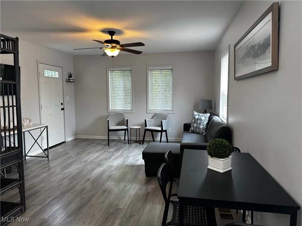 Living room featuring plenty of natural light, ceiling fan, and wood finished floors