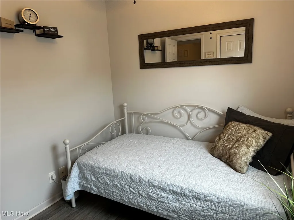 Bedroom featuring baseboards and wood finished floors