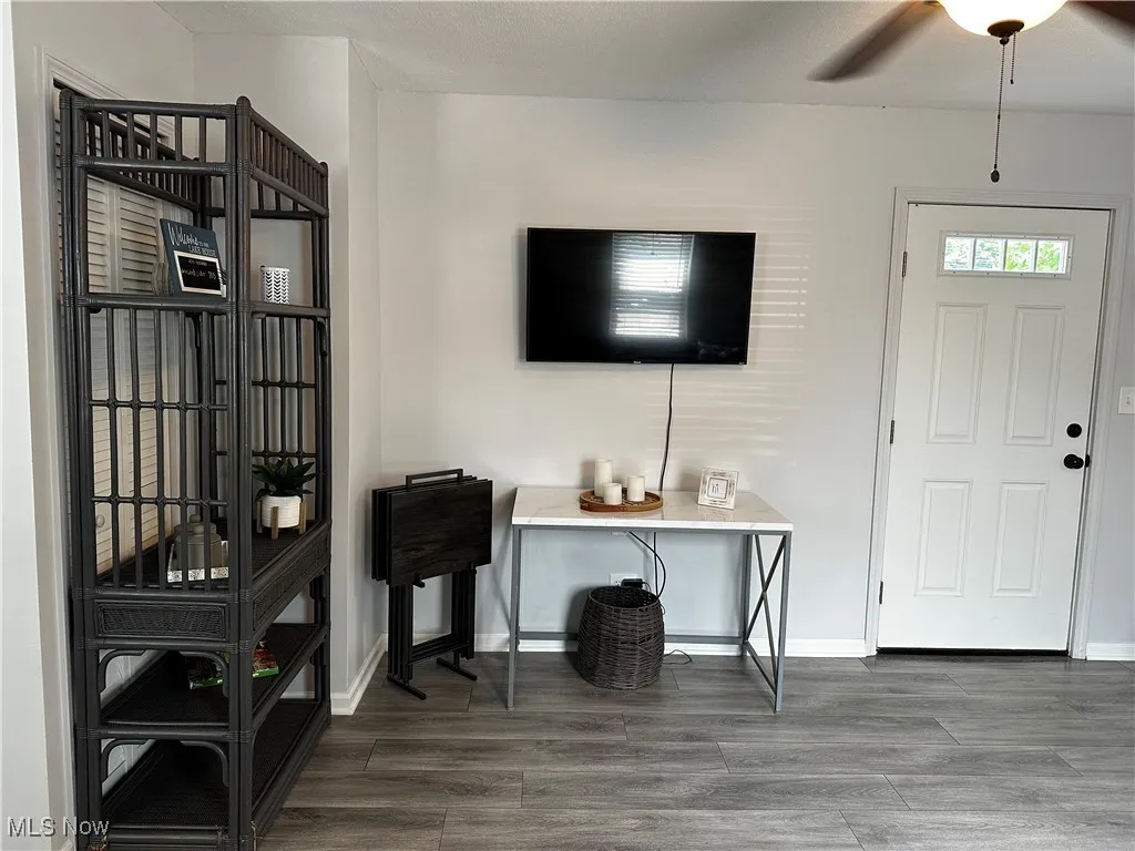 Foyer entrance with wood finished floors and a ceiling fan