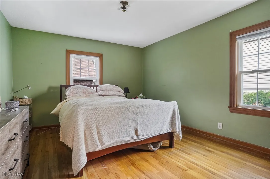 Master bedroom with double closets and hardwood flooring