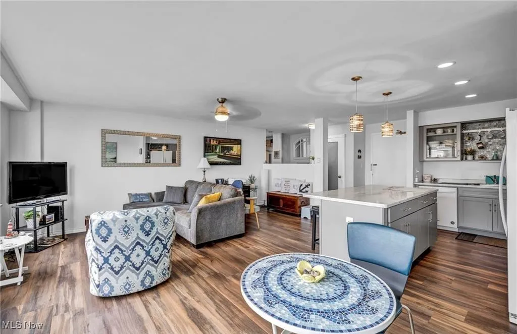 Living area with dark wood-style floors, recessed lighting, and a ceiling fan