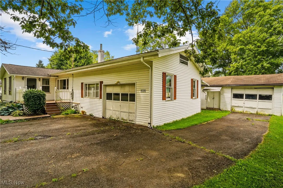 View of front facade featuring an attached garage and driveway