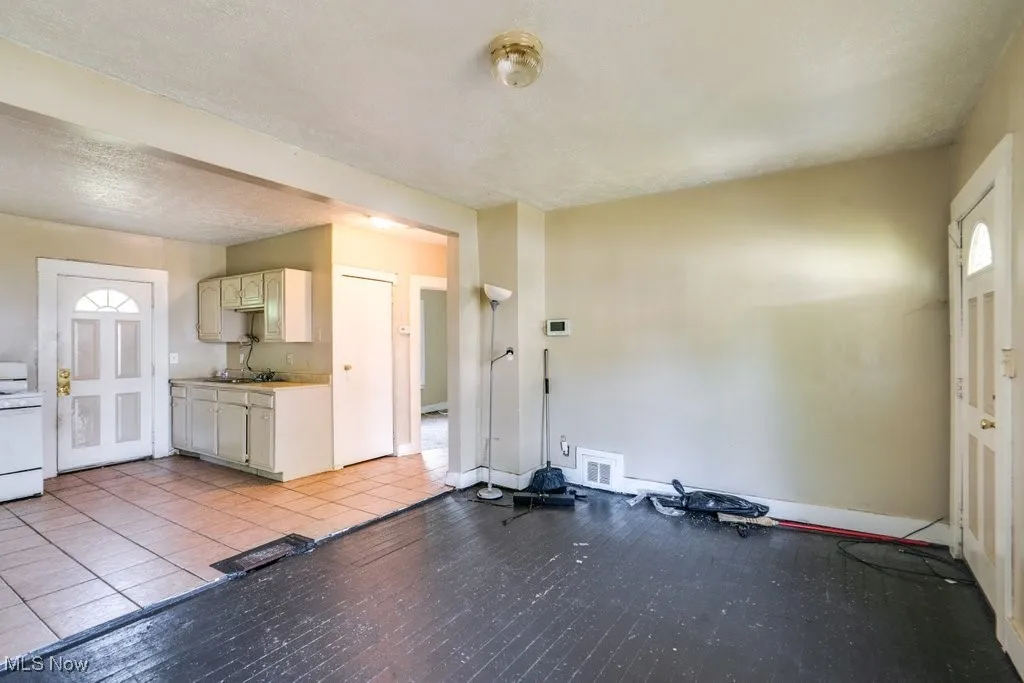 Exercise area with light wood-type flooring and baseboards