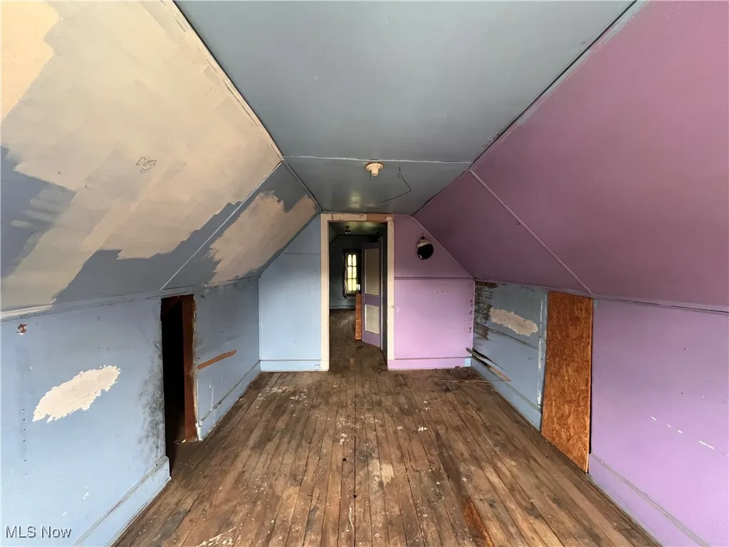 Bonus room featuring hardwood / wood-style floors and vaulted ceiling