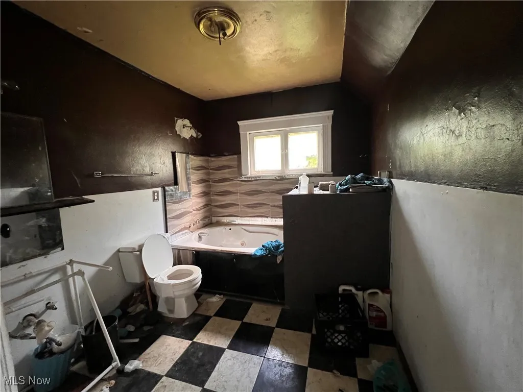 Full bathroom featuring a whirlpool tub and tile patterned floors