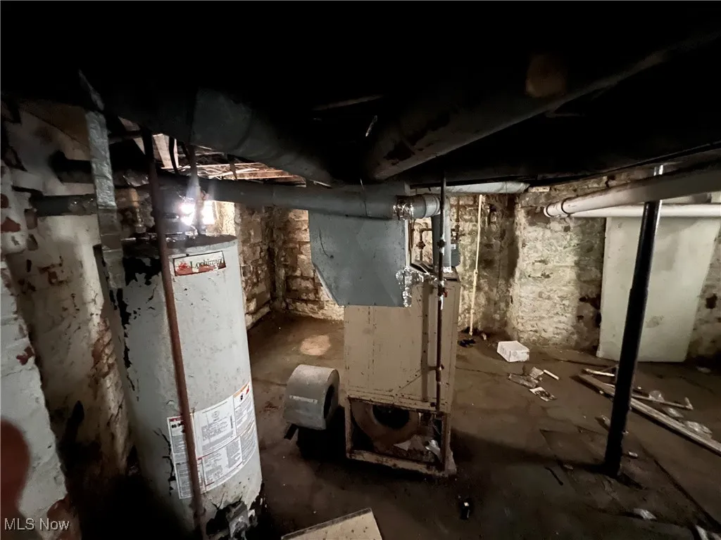 Unfinished basement with gas water heater and heating unit