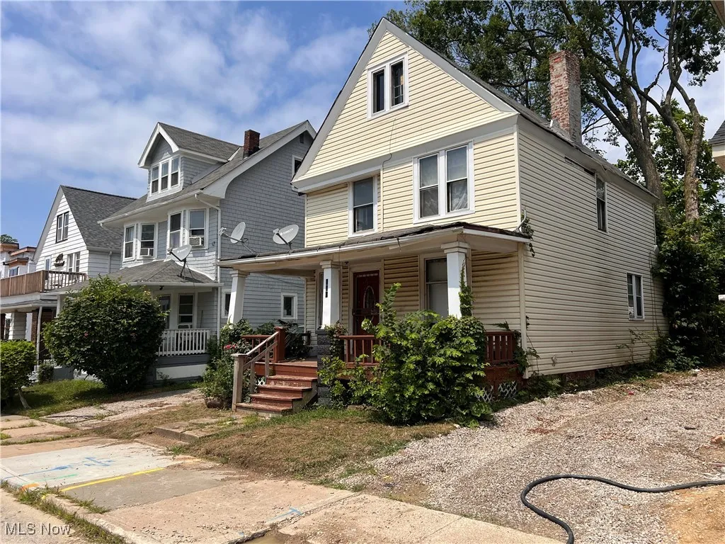 Traditional style home featuring a porch and a chimney