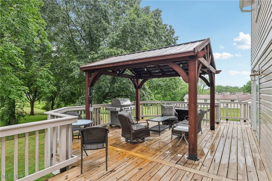 Deck with pergola and view of back yard