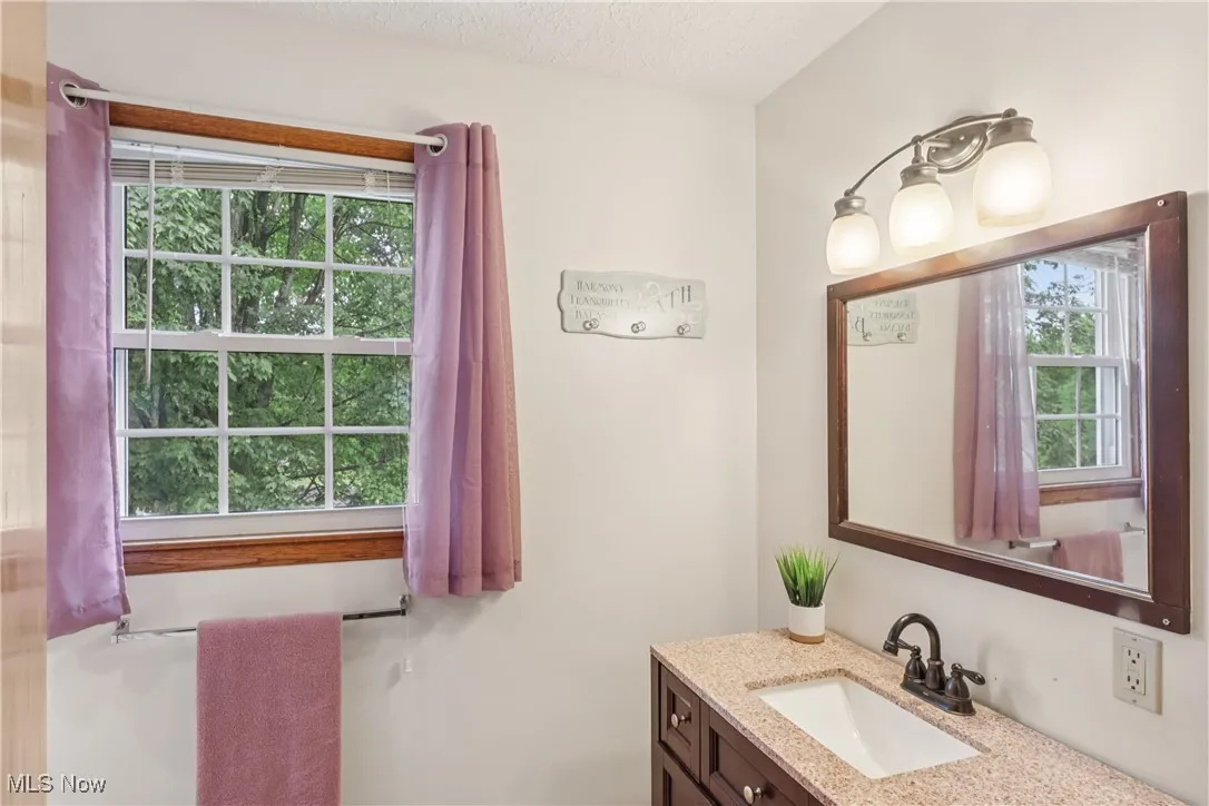 Second floor full bathroom with sink / vanity special lighting and shower & tub combo