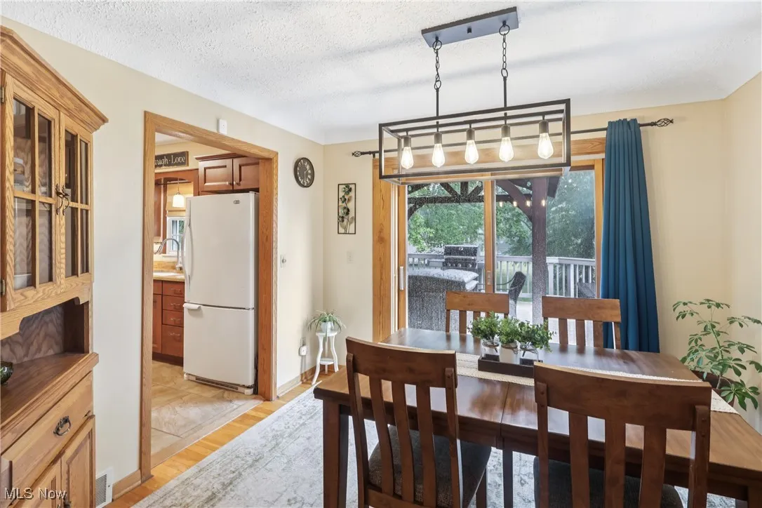 Dining room featuring a chandelier, slider to back deck and wood flooring
