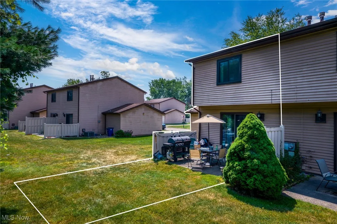 Rear view of property featuring a patio area