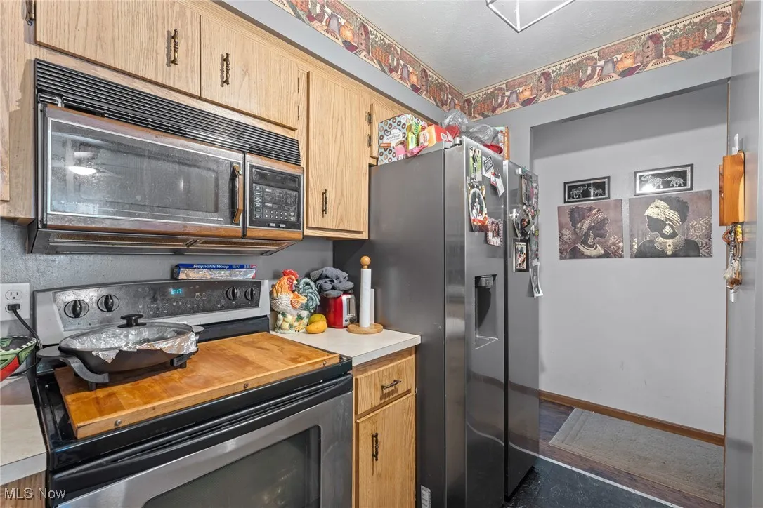 Kitchen featuring stainless steel appliances and light countertops