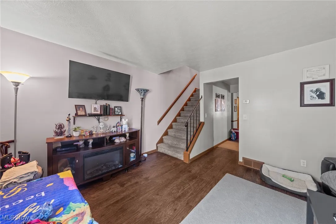 Living room with wood finished floors and stairs