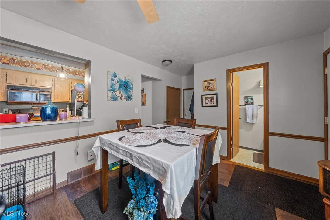 Dining room featuring wood finished floors and a textured ceiling