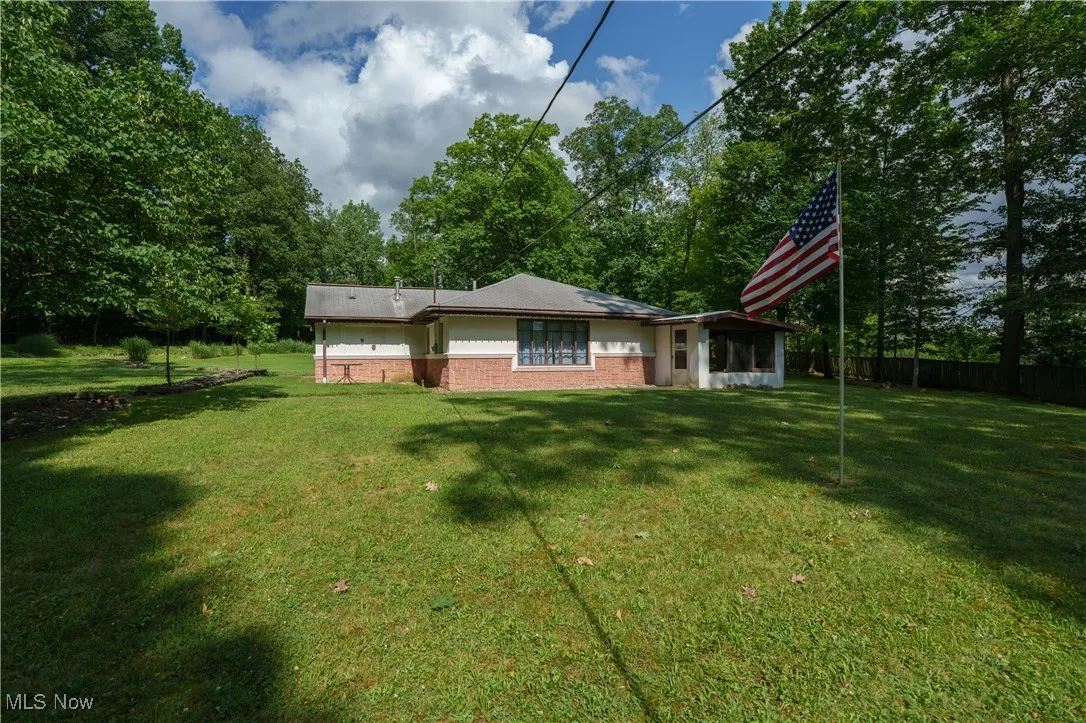 Back of property featuring brick siding