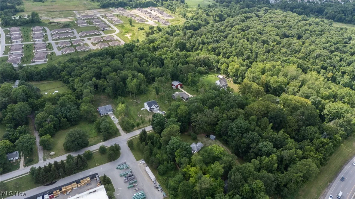 Aerial overview of property's location featuring a heavily wooded area