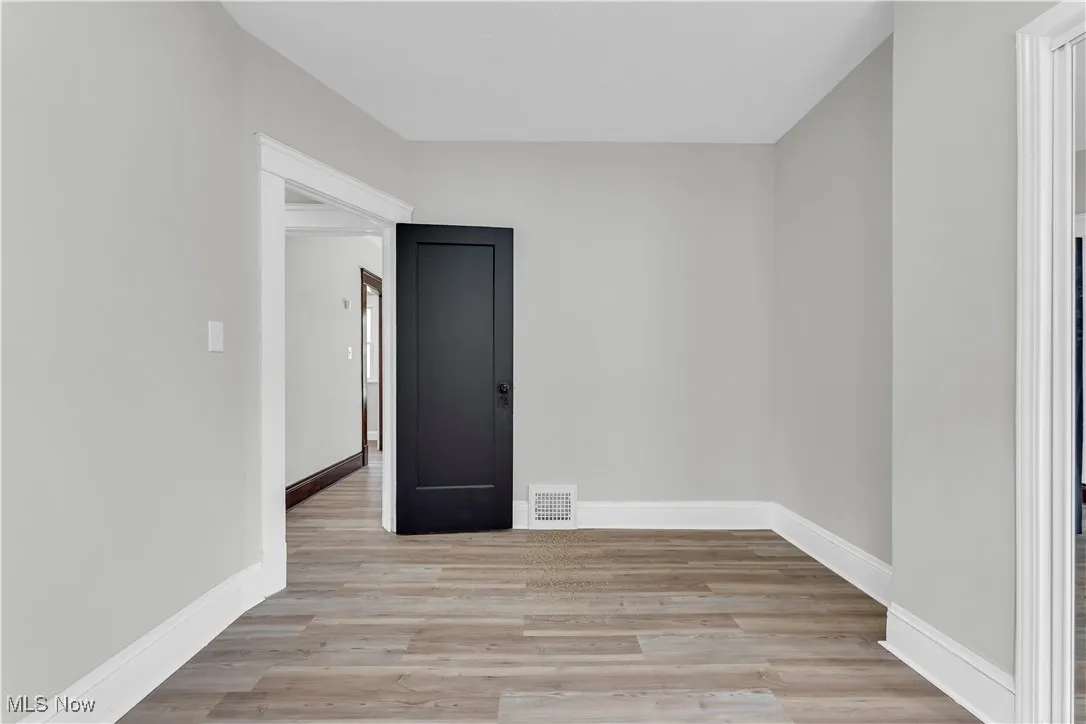 Unfurnished room featuring light wood-style floors and baseboards
