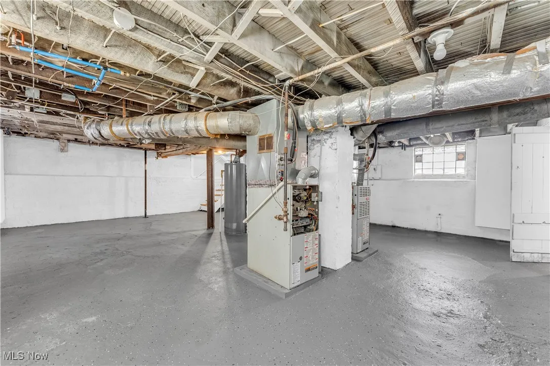 Below grade area with heating unit and gas water heater