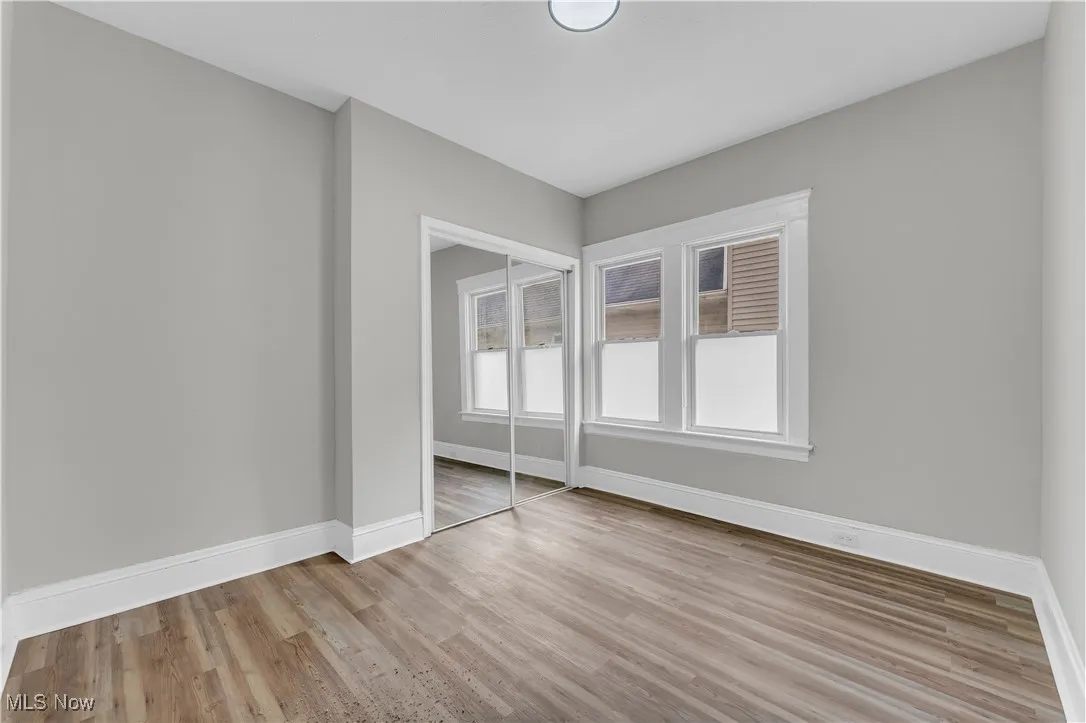 Unfurnished bedroom featuring a closet and wood finished floors