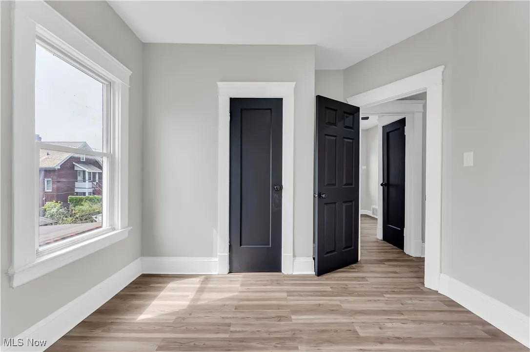 Unfurnished bedroom with light wood finished floors