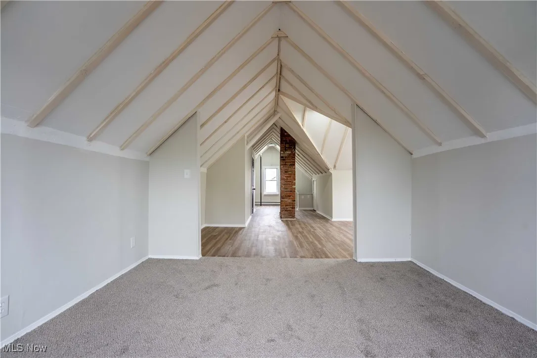 Additional living space featuring carpet floors and baseboards