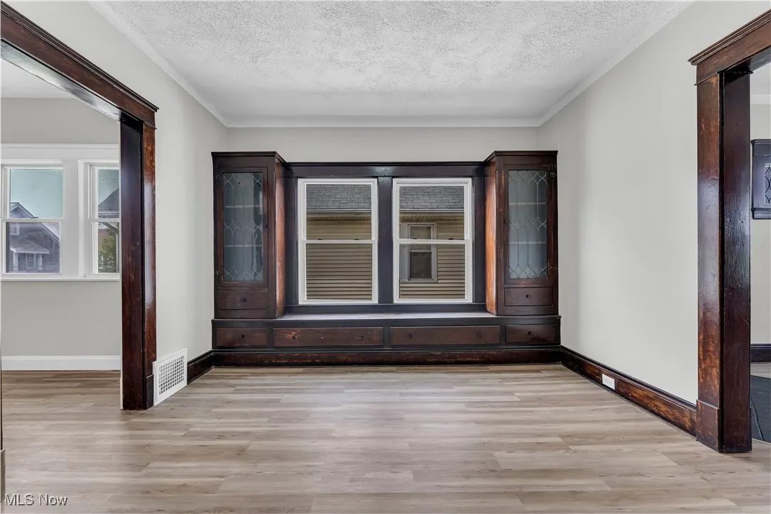 Spare room featuring a textured ceiling and light wood finished floors