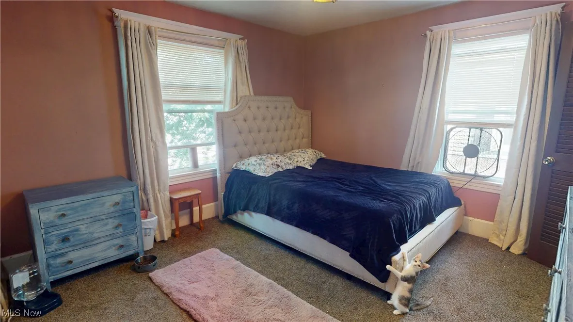 Carpeted bedroom with baseboards