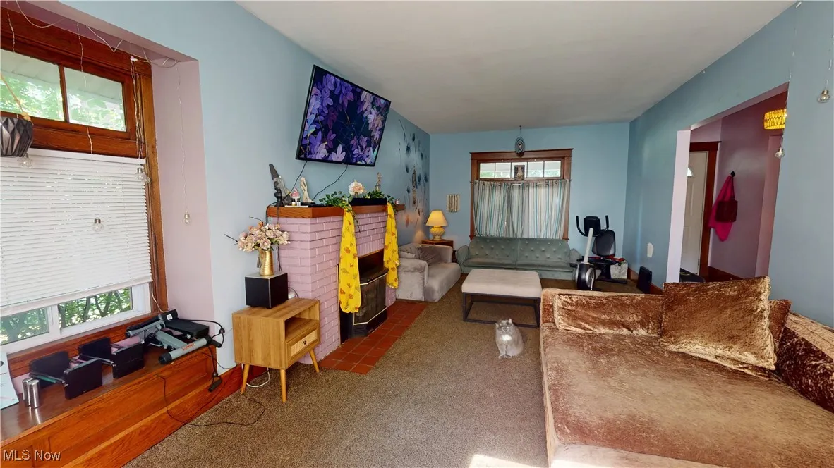 Living room featuring carpet flooring and plenty of natural light
